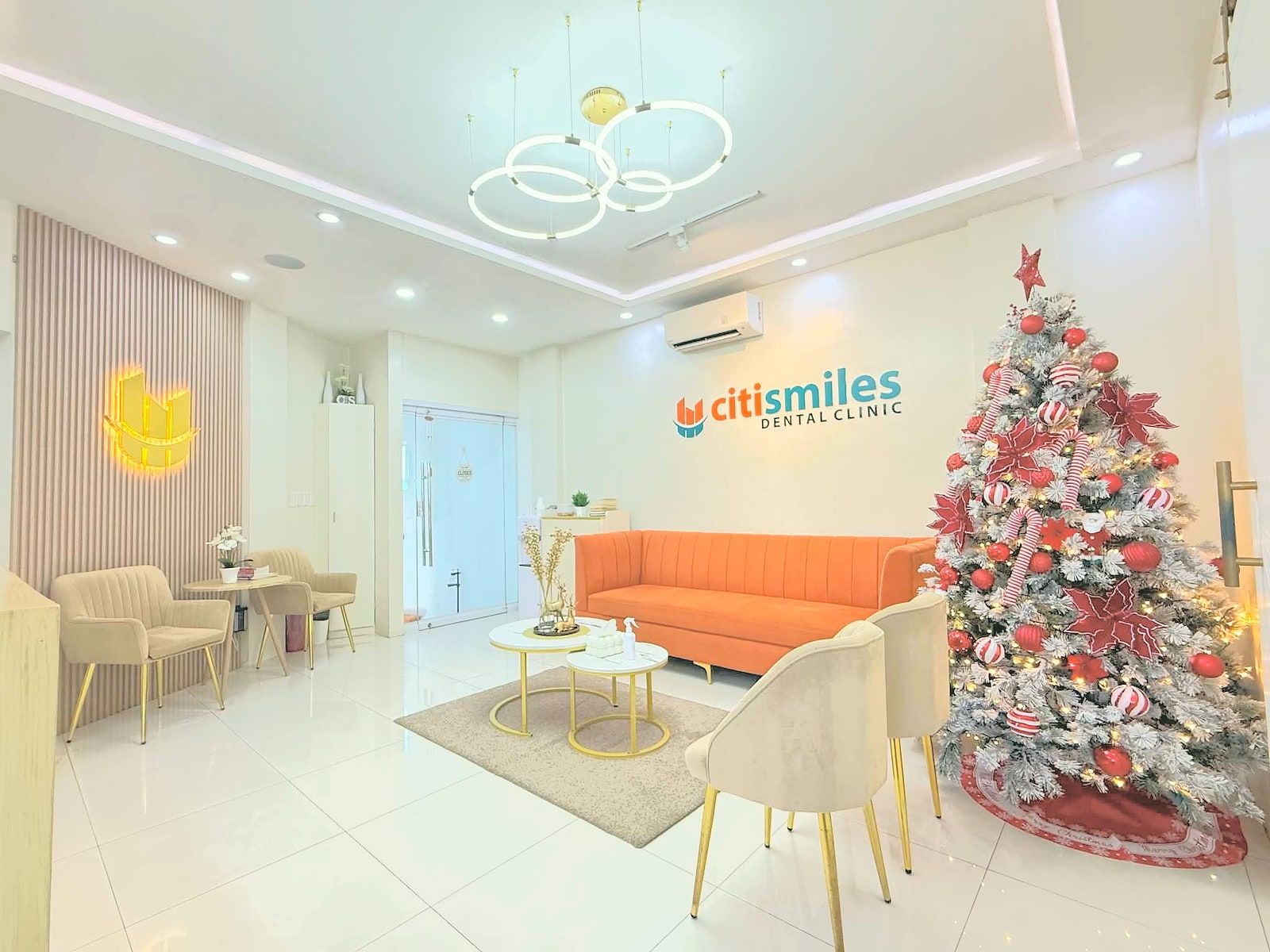 Waiting area with an orange sofa and the Citismiles sign at the clinic in Arayat, Pampanga